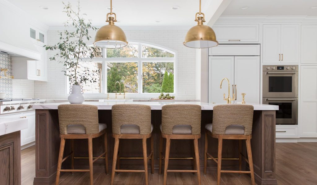 Indoor plants and wooden cutting boards softening the look of a stainless steel kitchen.