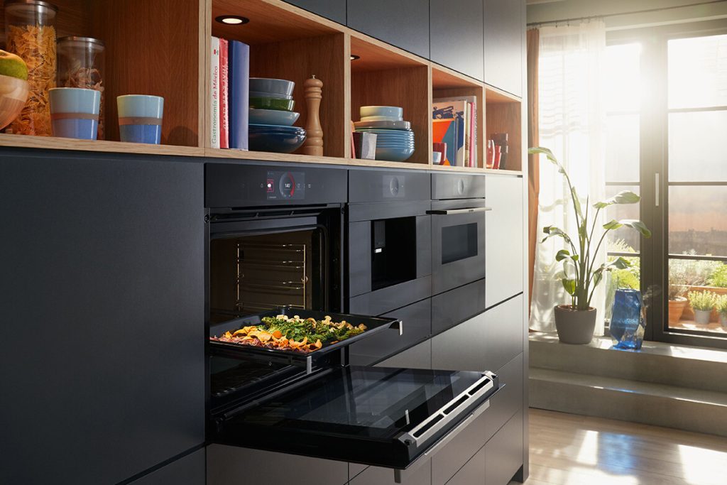 Sleek stainless steel refrigerator and oven blending seamlessly with kitchen design