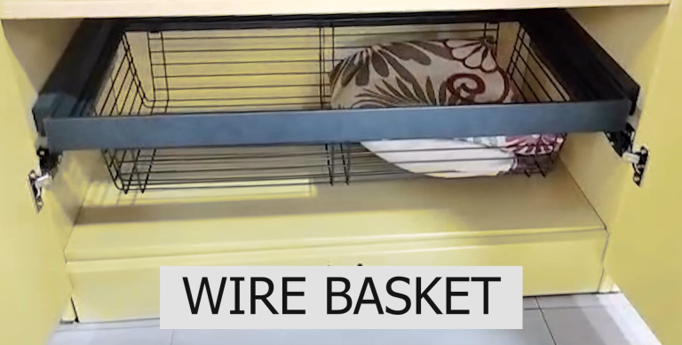 Wire baskets storing handbags and hats, mounted inside a wardrobe door.