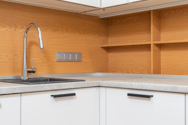 Modern stainless steel modular kitchen with sleek design.