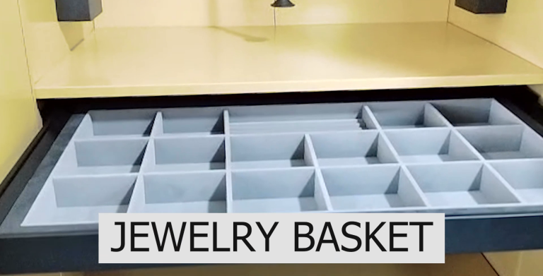 A soft-lined jewelry basket organizing bulkier jewelry pieces and scarves.