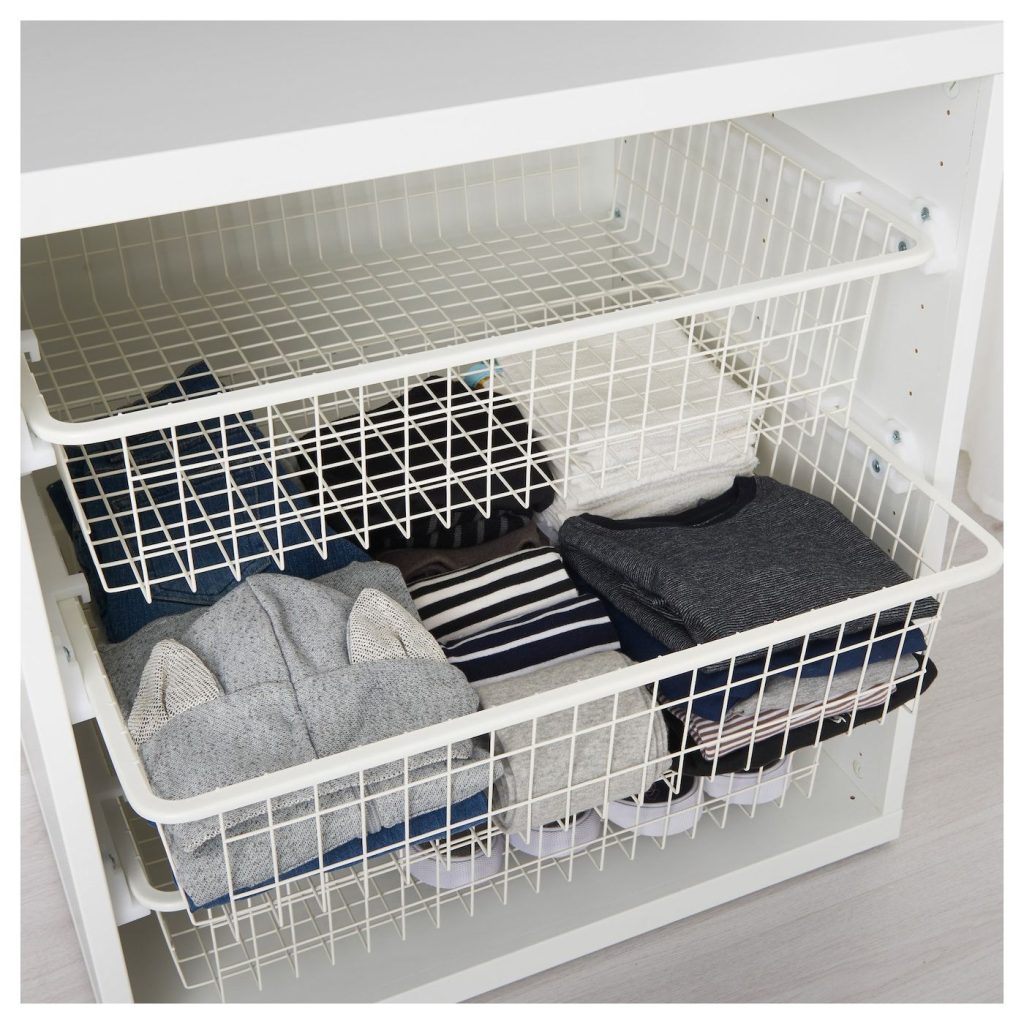 Wire baskets storing handbags and hats, mounted inside a wardrobe door.