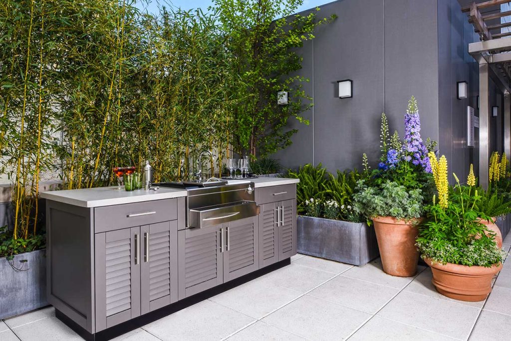 Stainless steel kitchen in an outdoor setting.
