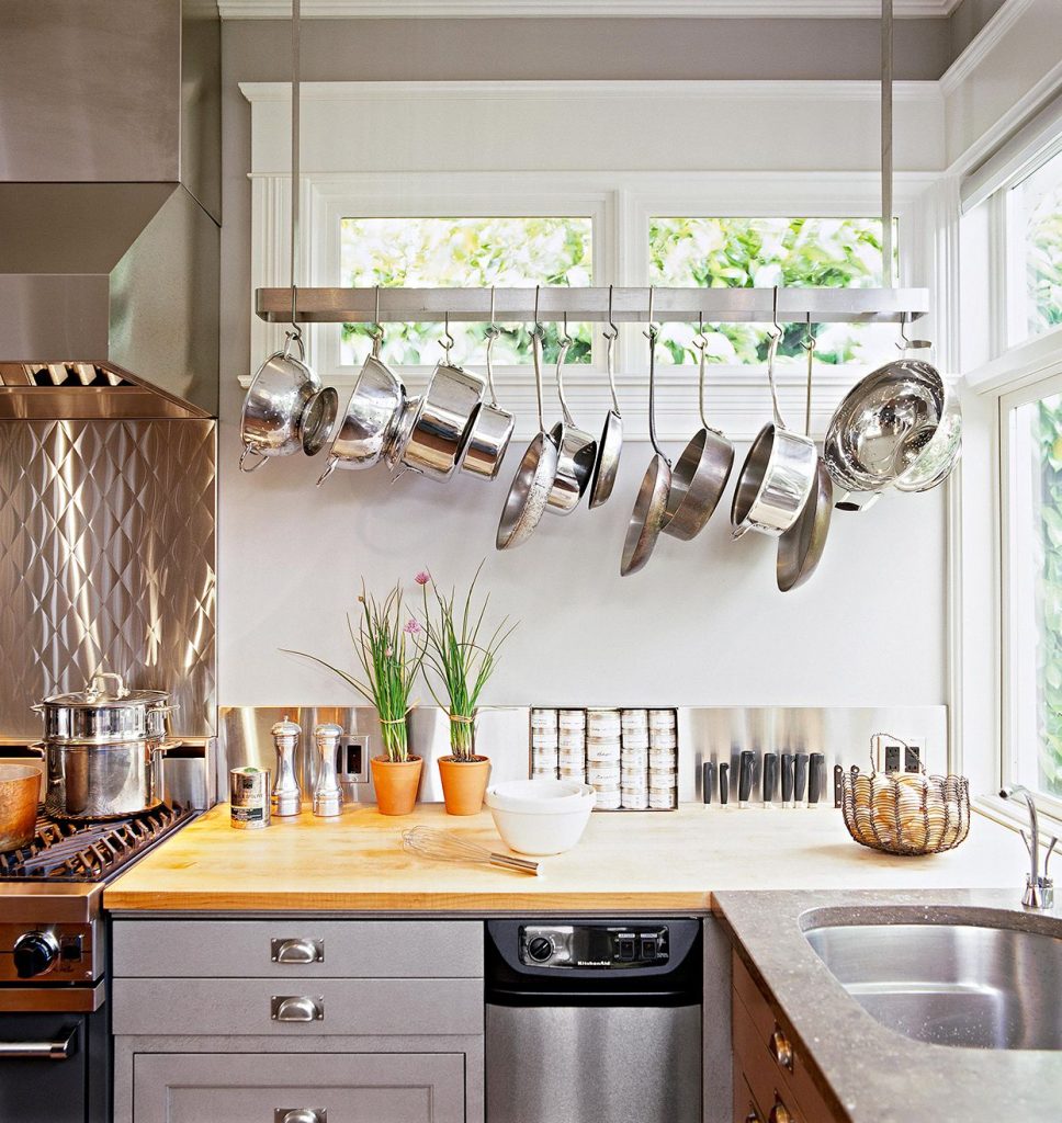 Kitchen with overhead pot racks. A kitchen featuring overhead pot racks, saving cabinet space and adding a decorative element bethliving